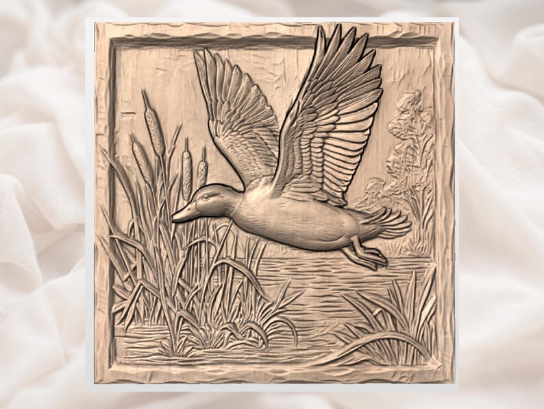 May include: A detailed wood carving of a duck in flight over water and reeds. The duck's wings are spread wide, and the carving is set within a rectangular frame. The artwork is in shades of brown and beige.
