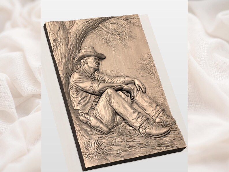 May include: A detailed relief carving of a cowboy resting against a tree. The artwork depicts a man in a cowboy hat, shirt, vest, and boots, with a bottle at his side. The carving is in shades of brown and tan, with intricate details.