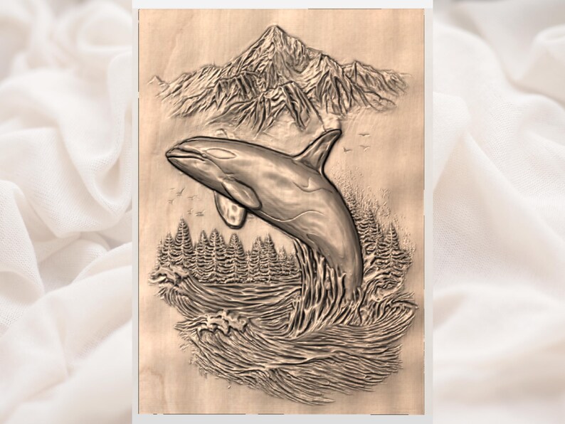 May include: A wooden carving depicting a breaching orca whale. The artwork features a detailed mountain range in the background, with a forest and waves in the foreground. The whale is gray, and the carving is on a light brown surface.
