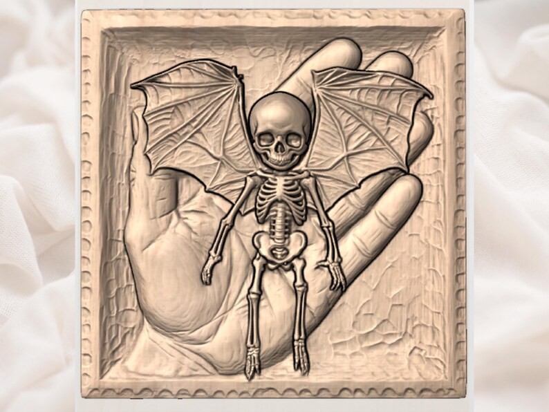 May include: A detailed relief carving of a skeletal figure with bat wings, held within a carved hand. The figure has a skull-like head and is set within a square frame with a decorative border. The artwork is in shades of brown.