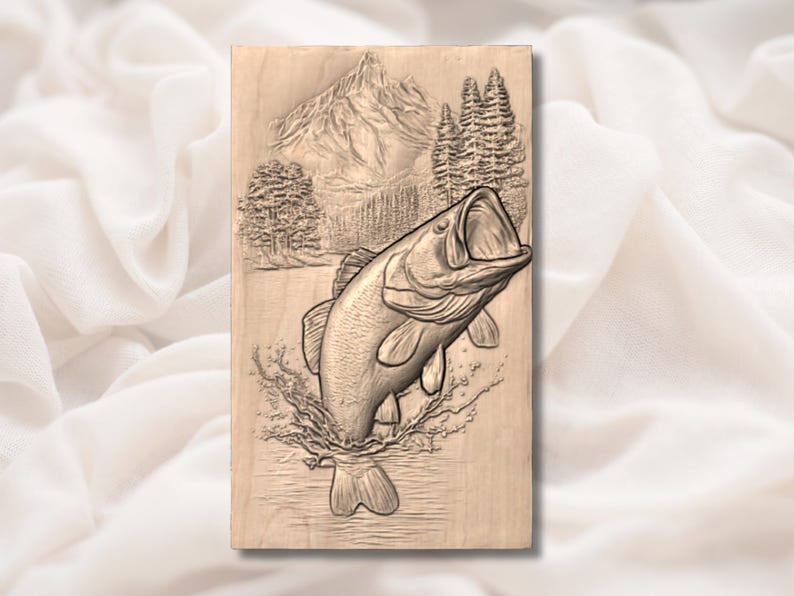 May include: A rectangular wooden carving of a leaping bass fish with an open mouth, emerging from water. The background shows a mountain range and pine trees. The carving is in shades of brown.