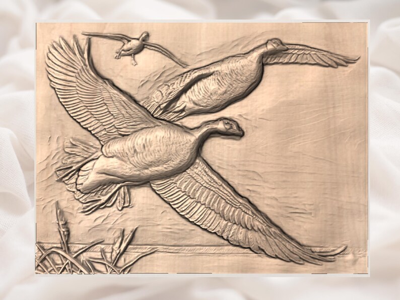 May include: A wooden relief carving shows three geese in flight. The geese are carved in detail, with outstretched wings and visible feathers. The background is a light brown, and the carving is mounted on a wooden panel.