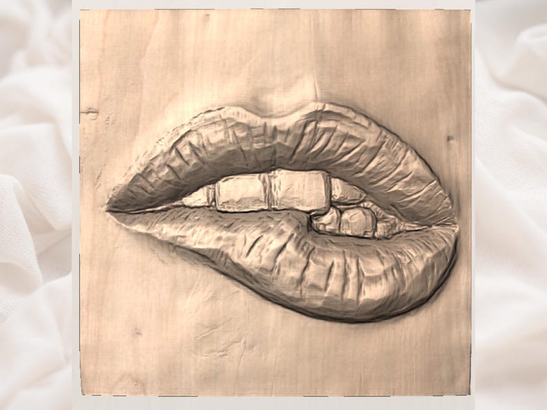 May include: A wooden carving of a pair of lips, with the lower lip slightly parted and the upper lip biting down. The teeth are visible. The carving is on a light brown wooden surface.