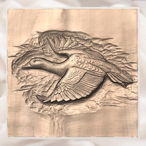 May include: A detailed wood carving of a duck in flight. The artwork features the duck with outstretched wings, carved in a natural wood tone. The carving is set against a textured background, creating a sense of depth and movement.