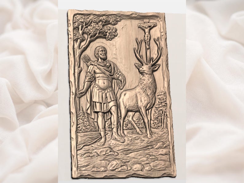 May include: A bronze-colored relief carving depicting a saint with a halo, holding a bow, standing beside a deer. The carving includes a tree, forest, and a depiction of the crucifixion. The overall theme is religious.