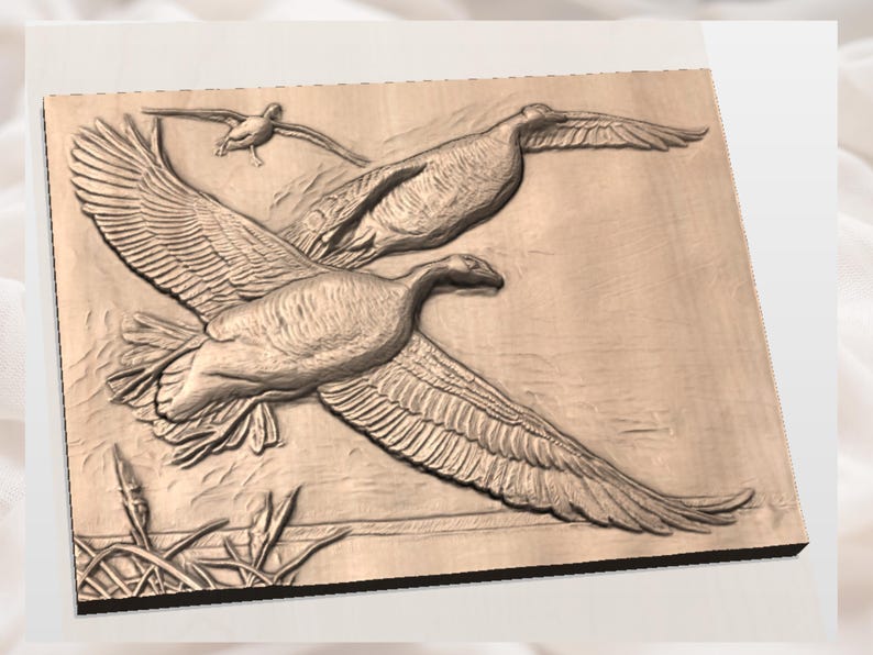 May include: A wooden relief carving of three geese in flight. The geese are depicted with detailed wings and feathers, set against a light brown background. The artwork captures the birds in mid-air, with reeds in the lower left corner.