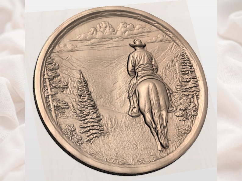 May include: A bronze-colored, circular relief sculpture depicting a cowboy on horseback, riding through a mountainous landscape. The detailed artwork includes trees, clouds, and a sense of depth, capturing a scene of the American West.