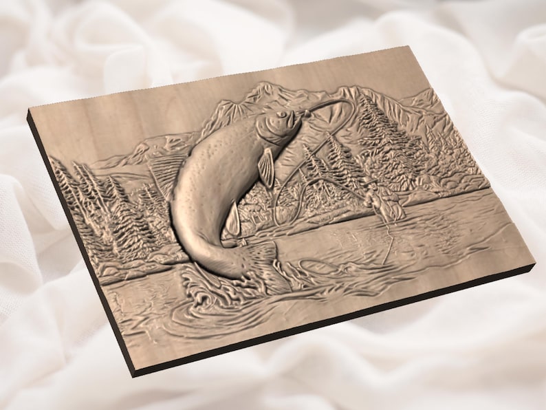 May include: A wooden relief carving of a fish leaping from water, with a fishing scene in the background. The artwork shows a detailed landscape with trees, mountains, and a river, all in shades of brown.