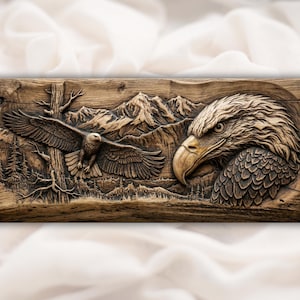 May include: A detailed wooden carving depicting an eagle in flight and a close-up of an eagle's head. The artwork features a mountain range and trees in the background, with a natural wood grain finish.