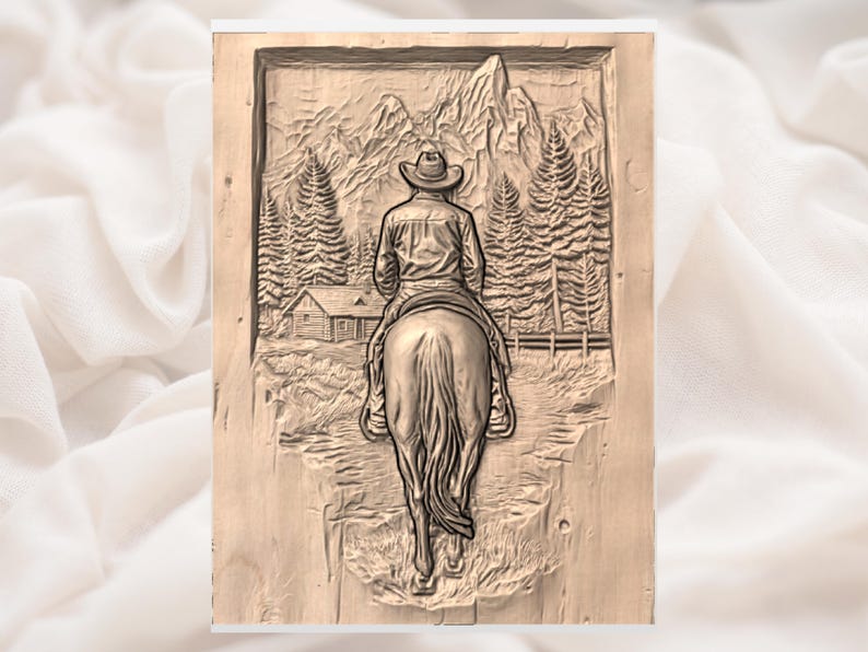 May include: A wooden relief carving depicts a cowboy on horseback, viewed from the back, riding through a mountain landscape. The carving includes a cabin, trees, and a fence, all rendered in a detailed, rustic style. The overall theme is Western and rustic decor.