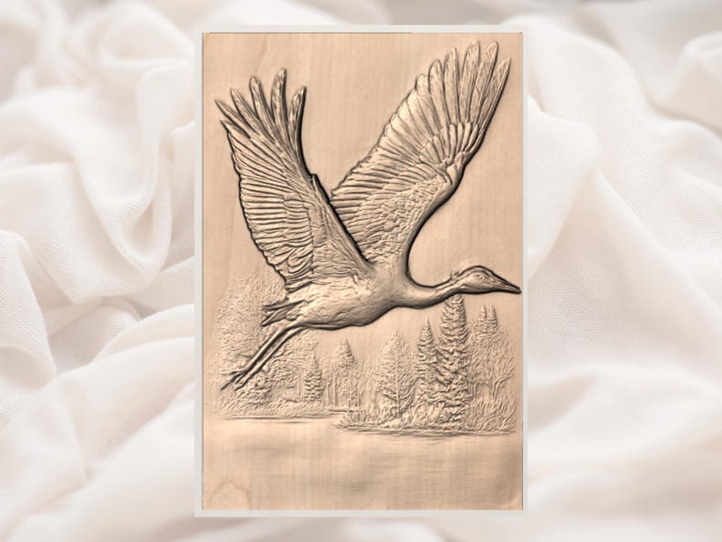 May include: A wooden relief carving of a crane in flight. The bird is depicted with outstretched wings, soaring above a detailed landscape of trees and water. The artwork is rendered in shades of brown and tan.