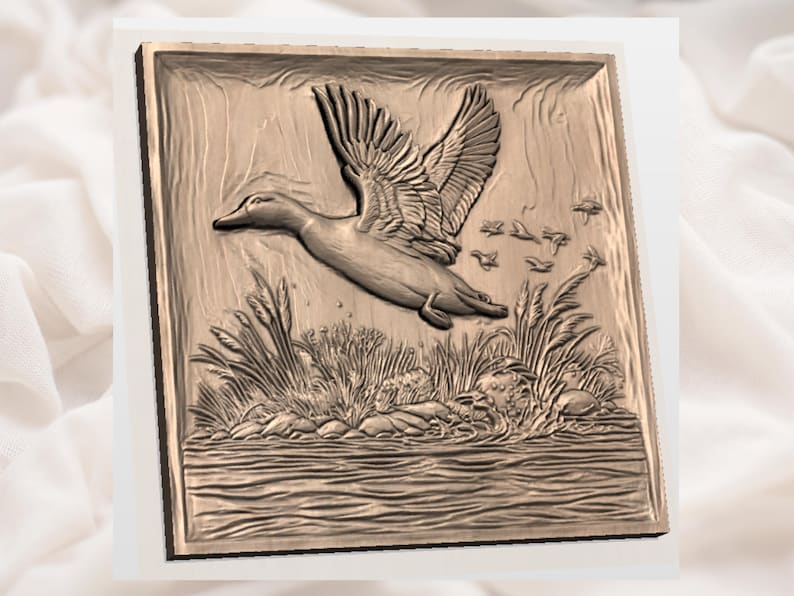 May include: A bronze-colored relief carving of a duck in flight over water and reeds. The duck is depicted with outstretched wings, and several smaller birds are also visible. The artwork is framed within a square border, suggesting a decorative piece.