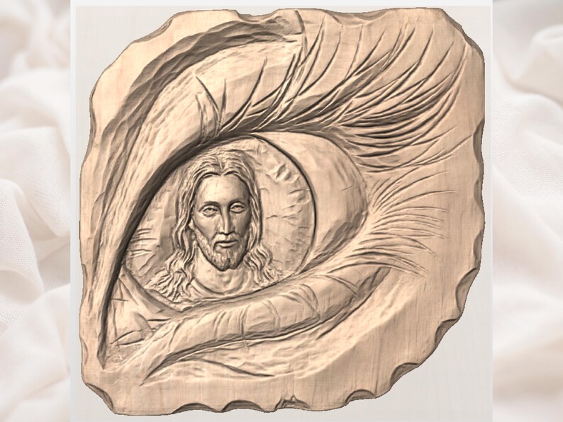May include: A wooden carving of Jesus Christ within an eye-shaped frame. The carving is in shades of brown, with detailed textures and lines. The face of Jesus is centered, with long hair and a beard.