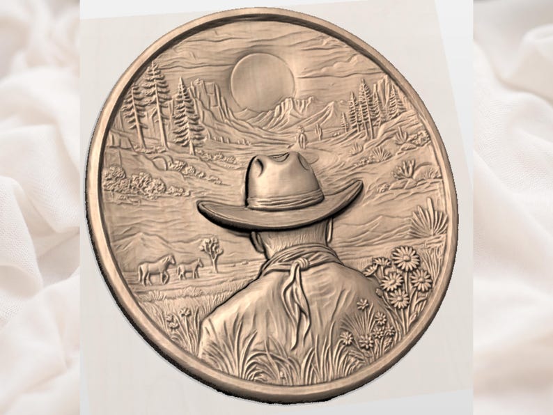 May include: A bronze-coloured, circular relief carving depicting a cowboy in a hat, facing a desert landscape with mountains, trees, and a sun. The cowboy is in the foreground, with horses and flowers in the distance.
