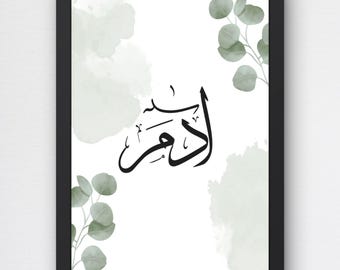 May include: A framed poster featuring black Arabic calligraphy in the center, surrounded by soft sage green watercolor splashes and delicate eucalyptus leaf illustrations on a white background. The text at the top reads PERSONALISIERTES NAMENSPOSTER ARABISCHE ODER LATEINISCHE KALLIGRAFIE and at the bottom DIGITALES PRODUKT PDF.