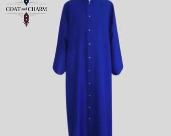 May include: A long, royal blue robe with a mandarin collar and a row of white buttons down the front. The robe has long sleeves and is made of a smooth fabric. The text "COAT and CHARM" is in the upper left corner.