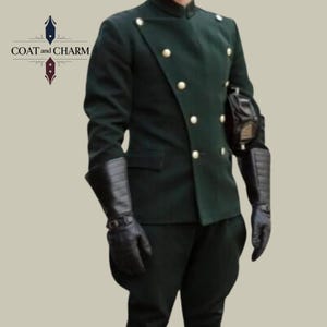 May include: Dark green military-style jacket with gold buttons and a high collar. The jacket is paired with matching dark green pants and black leather gloves. The image includes the text "COAT and CHARM" in the upper left corner.