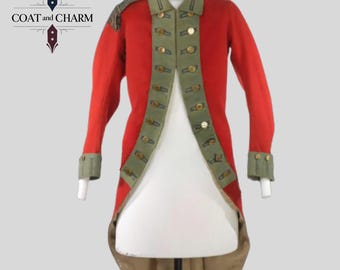 May include: A red military-style coat with olive green trim and gold buttons. The coat features a high collar and long sleeves with cuffs. The coat is displayed on a white mannequin. The Coat and Charm logo is in the upper left corner.