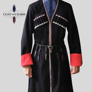 May include: Black coat with red cuffs and white trim, featuring a black belt. The coat has decorative pockets and a V-neck design. The text "COAT and CHARM" is visible in the upper left corner.