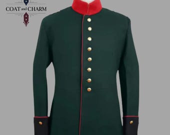 May include: A dark green military-style jacket with a red collar and trim, featuring gold buttons down the front. The sleeves have black cuffs with gold buttons. The jacket is displayed on a mannequin.