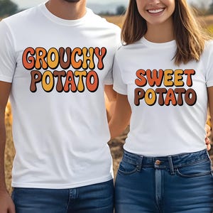 May include: White t-shirts with the phrases "Grouchy Potato" and "Sweet Potato" in retro-style orange, brown, and yellow lettering. The shirts are worn by two people, with a pumpkin patch in the background.