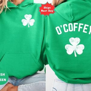May include: Green hoodie with a white shamrock on the front and back. The back of the hoodie has the name "O'COFFEY" printed in white. The front of the hoodie has the words "Irish Green" printed on the bottom.