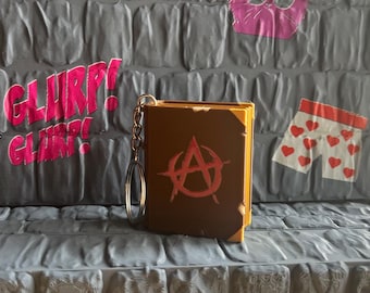 Llavero del libro de cocina anarquista de Carl, el explorador de mazmorras