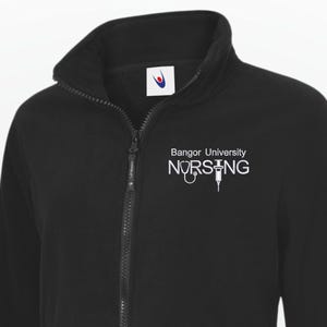 May include: Black fleece jacket with a full zip and a high collar. The jacket displays the text "Bangor University NURSING" in white on the chest. A warm and practical outerwear garment.