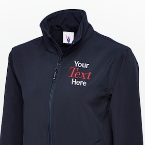 May include: Navy blue jacket with a full zip, a stand-up collar, and a small chest pocket. The text "Your Text Here" is embroidered in red on the chest. The jacket is made of a smooth, water-resistant material.