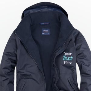 May include: Navy blue hooded jacket with a zip-up front. The jacket has a soft interior lining and features the text "Your Text Here" in teal on the front. The jacket has a high collar and a hood.
