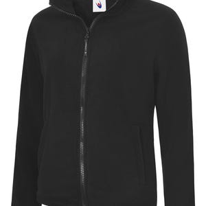 May include: A black fleece jacket featuring a full-length zip and a high collar. The jacket has two side pockets and a small logo on the chest. The material looks soft and warm, ideal for cooler weather.