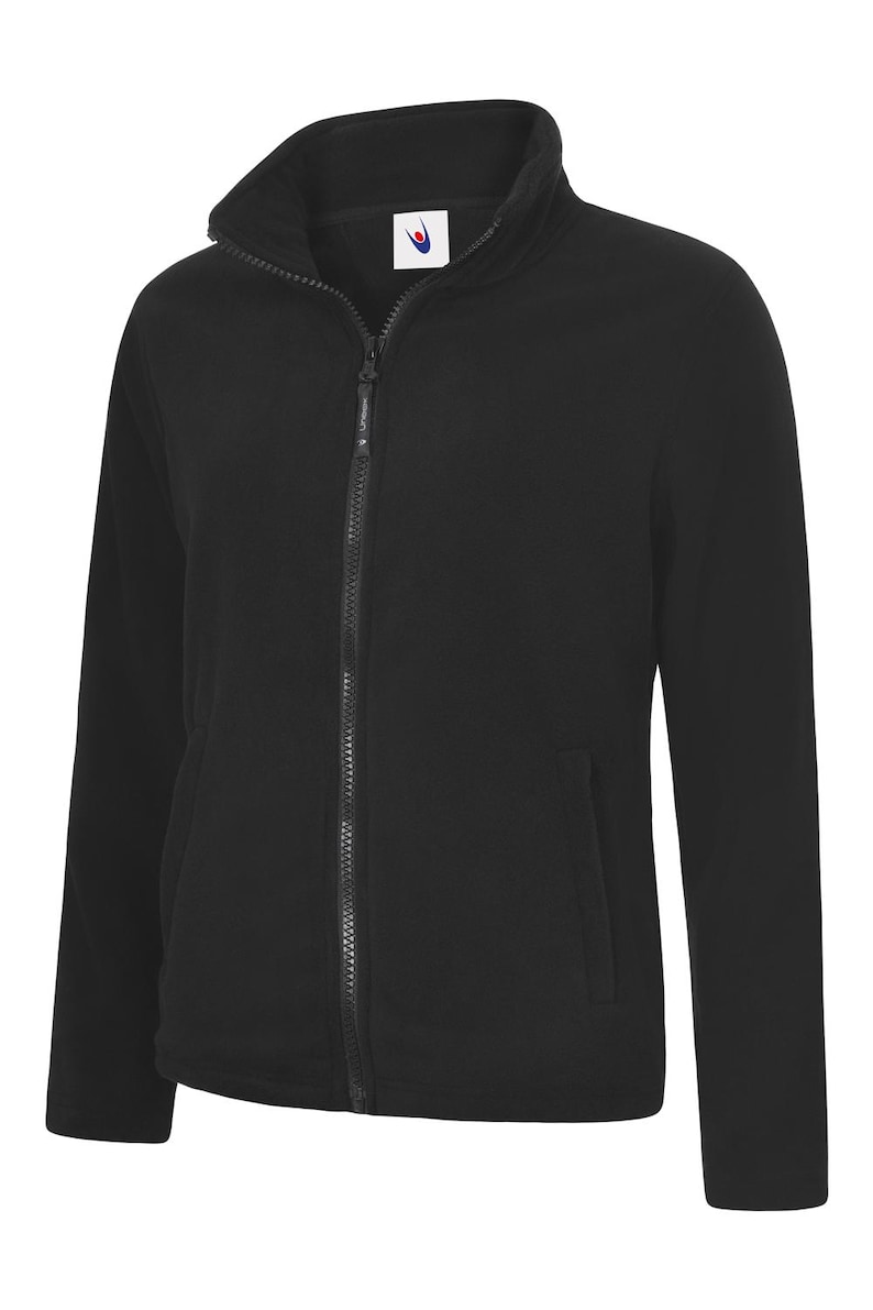 May include: A black fleece jacket featuring a full-length zip and a high collar. The jacket has two side pockets and a small logo on the chest. The material looks soft and warm, ideal for cooler weather.