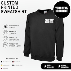 May include: A black long-sleeve sweatshirt featuring a crew neckline and a white text graphic on the chest that reads YOUR TEXT/LOGO HERE. The image includes text labels for custom printed sweatshirt, professional printed, premium quality, and durable.