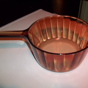 May include: A set of three ceramic nesting bowls in shades of blue, green, and white. The bowls feature a speckled glaze and a simple, modern design. The largest bowl is approximately 6 inches in diameter.