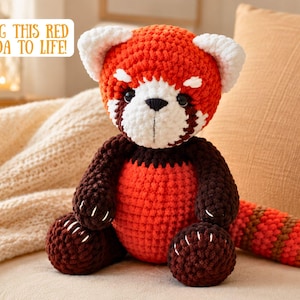 May include: A crocheted red panda plush toy with a vibrant orange head, white ear tips, and a white face mask. It features dark brown limbs and a striped orange and brown tail. The text "BRING THIS RED PANDA TO LIFE!" appears in the upper left corner.