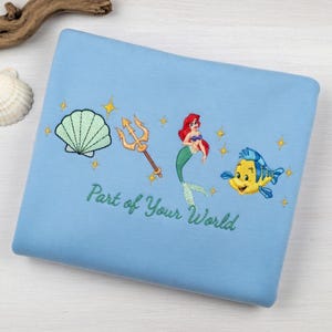 May include: A set of three ceramic mugs with a speckled, matte finish. The mugs are in shades of cream, light gray, and dark gray. Each mug has a simple, minimalist design and a rounded handle. The mugs are stacked on top of each other.