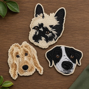 May include: Three embroidered dog head patches featuring a cream and black terrier, a golden-brown shaggy-haired dog, and a black and white dog with floppy ears. Each patch displays detailed stitching to represent fur texture and facial features.