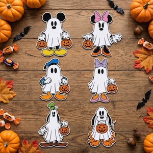 May include: Six die-cut stickers featuring cartoon characters dressed as ghosts for Halloween. Each character wears a white sheet and carries an orange jack-o'-lantern bucket. The set includes Mickey, Minnie, Donald, Daisy, Goofy, and Pluto figures.