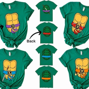 May include: Four green t-shirts featuring yellow turtle shells on the front with coloured masks and weapons, and corresponding turtle shell designs on the back. The shirts include letters D, R, L, and M on the front masks. Text labels Front and Back.