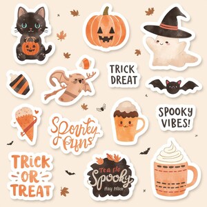 May include: A selection of Halloween stickers. The designs include a black cat with a pumpkin, a carved pumpkin, a ghost in a witch's hat, and a bat. Text includes "Trick or Treat" and "Spooky Vibes!"