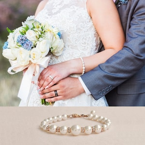 May include: A pearl bracelet with small clear crystals on a white background.