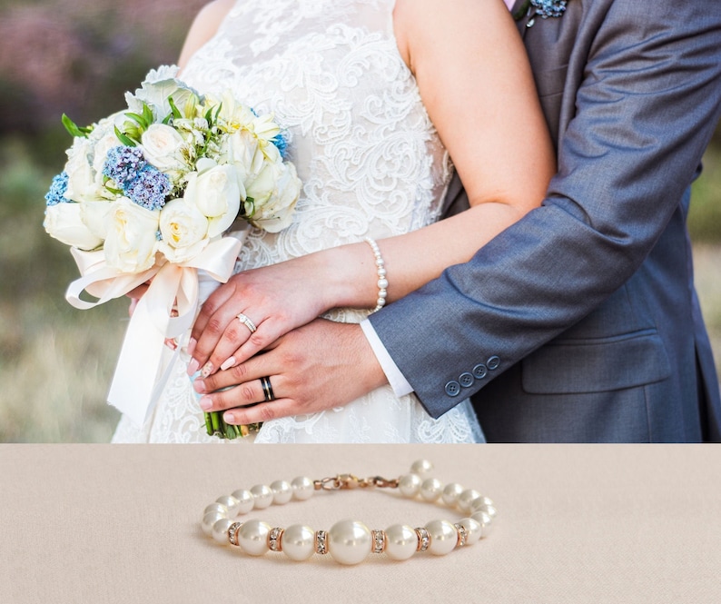 May include: A pearl bracelet with small clear crystals on a white background.