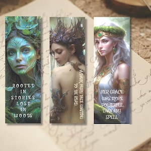 May include: Three rectangular bookmarks featuring fantasy illustrations of figures. The first shows a green-toned forest figure with the text ROOTED IN STORIES LOST IN WOODS. The second shows a dark figure with the text A DARK FAIRY TALE WAITING TO BE READ. The third shows a white-haired figure with the text HER GRACE WAS MORE POWERFUL THAN ANY SPELL.