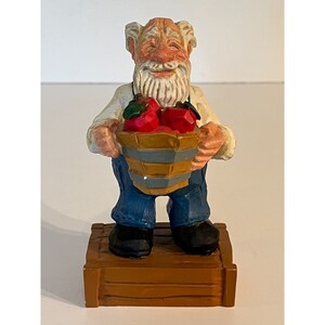 David Frykman figurine 1995 David Frykman The Old Farmer Holding Apple Figurine Resin with Wood Carved Look 7 1/2 Tall by Coynes Inc