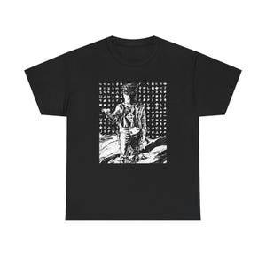 May include: Black t-shirt with a monochrome graphic of a masked figure holding an object, with a cross symbol. The graphic is surrounded by a grid of symbols and letters. The shirt is made of a soft material.