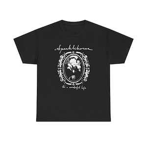 May include: Black t-shirt with a white graphic. The graphic features the text "Sparklehorse" above an oval frame with a floral design and a face. Below the frame is the text "its a wonderful life".