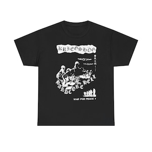 May include: Black t-shirt with a white graphic design. The design includes the text "Kriegshög" above a graphic of figures and the words "Hardcore Hell". Below the graphic is the text "War for Peace?"
