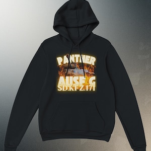 May include: Black hooded sweatshirt with a front graphic. The graphic features the text "PANTHER AUSF. G SD.KFZ.171" in a glowing yellow font, with a tank image engulfed in flames. The sweatshirt has a kangaroo pocket and a drawstring hood.
