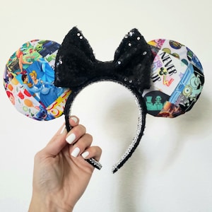 May include: Black sequined bow headband with patterned ears featuring Disney characters. The ears have a patchwork design with images from various Disney movies. The headband is black with silver trim.