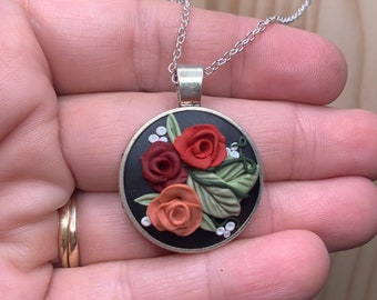 Handmade Necklace - various red roses on black background. This one looks amazing with a red dress or shirt. I get tons of compliments.